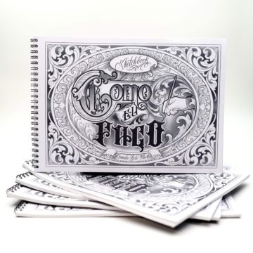 Tattoo sketchbook cover with intricate black and white design.