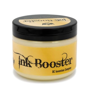 Tattoo ink booster in yellow container with black lid from Pedrada Tattoo Supplies.