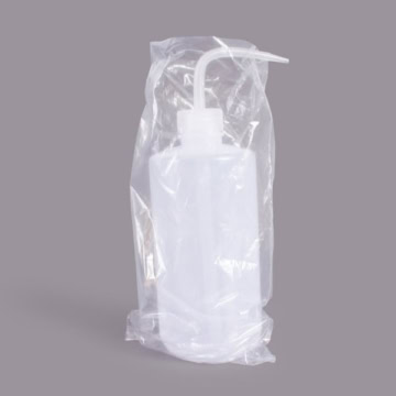 Disposable spray nozzle cover in plastic packaging for tattoo supplies.