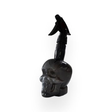 Skull-shaped water spray bottle for tattooing and art.