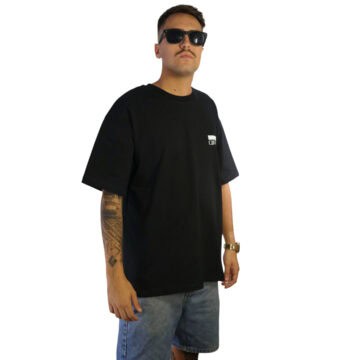 Man in black Calligraffiti T-shirt with sunglasses and tattoos.