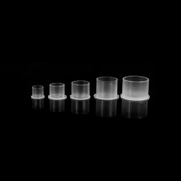 Set of five tattoo ink cups in various sizes for tattooing.