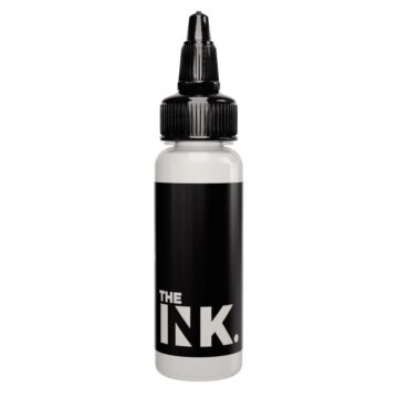 White tattoo ink bottle with black label and nozzle cap.